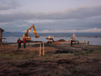 Taken by Petty Officer 1st Class Karen Sinkey. Contractors begin night operations at Indian Island in Eureka, CA. Night operations were necessary for the continued progress of on-site remediation while high tides peaked in the late evening.